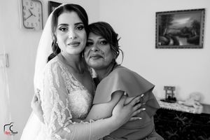 Black and white photo of two people sharing an emotional moment before a wedding ceremony.