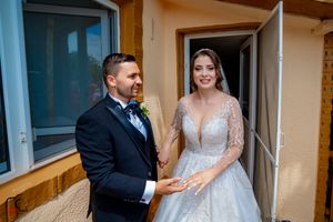 Joyful first look wedding sequence captured at venue entrance with blue doors.