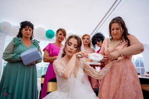 Wedding celebration showing guests in formal attire with teal balloons in background.