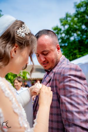 Close-up emotional moments during outdoor wedding celebration under white tent.