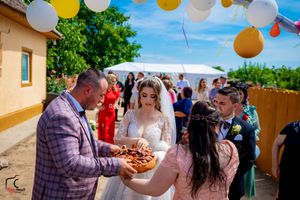 Garden party setup with hanging lanterns and balloons against a bright blue sky.