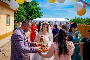Outdoor party scene with festive decorations and guests mingling in a sunny garden setting.