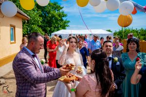 Festive gathering in an outdoor setting with decorative balloons and party atmosphere.
