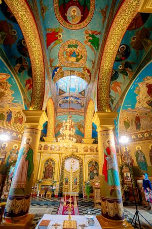 Stunning Byzantine-style church interior with painted ceiling and ornate gold details.