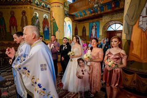 Traditional Orthodox marriage ceremony with clergy performing sacred rites at the altar.