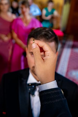 Close-up of a person receiving a blessing during an Orthodox wedding ceremony.
