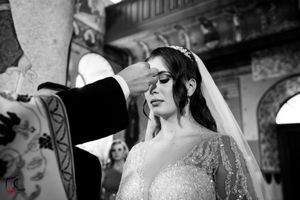 Black and white photo of a wedding ceremony in an ornately decorated religious setting.