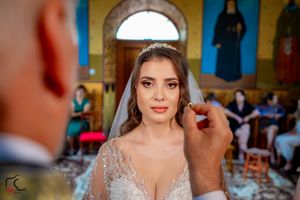 Close-up shot of a wedding ceremony in progress within an ornate Orthodox church setting.