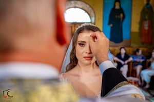 Wedding photography session inside a church with yellow walls and decorative artwork.