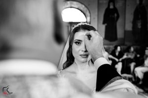 Black and white portrait of a bride during her wedding ceremony in a traditional church setting.