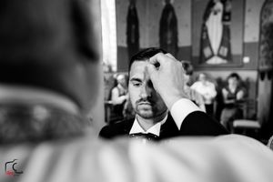 Artistic black and white wedding photograph taken inside a traditional church setting.