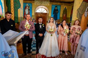 Wedding celebration in a Byzantine church featuring colorful frescoes and traditional religious artwork.