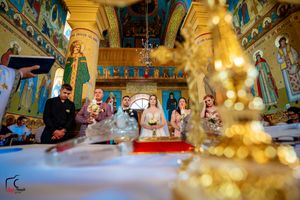 Artistic wedding photography through crystal decorations in an Orthodox church setting.