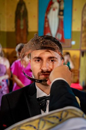 Candid moment captured during a formal wedding celebration in a decorated church setting.