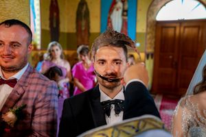 Wedding guests mingling inside a beautifully decorated traditional church.