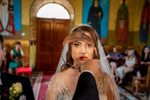 Intimate wedding ceremony moment captured in a historic church with golden walls.