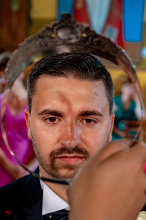 Candid wedding moment captured in an ornately decorated church interior.