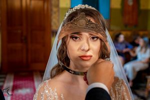 Orthodox wedding ceremony in an ornate church with traditional crowning ritual and decorative interior.