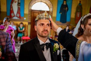 Traditional Orthodox marriage ceremony with decorative crowns and religious iconography.
