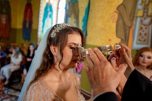 Orthodox wedding ceremony shows couple drinking from ceremonial cups in an ornate church interior.