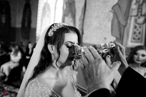 Black and white photo of traditional wedding ritual with ceremonial drinking cups.