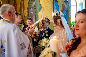 Panoramic view of a wedding celebration inside a historic church with vibrant yellow and blue decor.