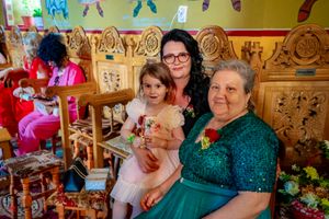Wedding guests gathered in a colorfully decorated church hall with yellow walls.