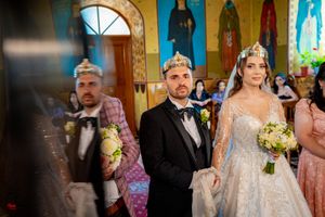 Wedding processional in an ornate church featuring distinctive yellow walls and blue trim.