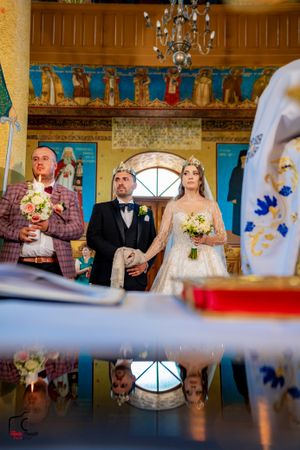 Elegant church wedding ceremony captured through artistic framing and natural lighting.