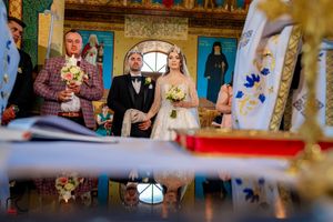 Wedding ceremony moments captured in a church with vibrant murals and decorative elements.