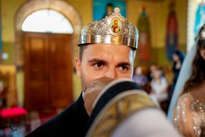 Close-up of ceremonial crown during an Orthodox wedding ceremony in a church.