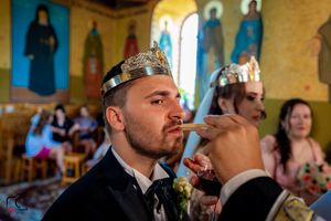 Close-up of ceremonial wine drinking during Orthodox wedding ritual.