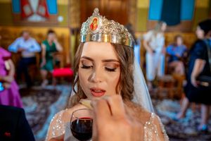 Ornate crown adorned with jewels during traditional Orthodox wedding ceremony.