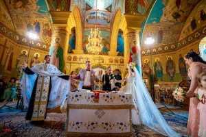 Panoramic view of Orthodox wedding ceremony showing elaborate church architecture and gathered congregation.