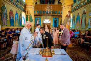 Traditional Orthodox Christian wedding service with elaborate church architecture and iconography.