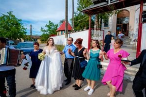 Wedding guests perform choreographed dance moves in a festive outdoor celebration.