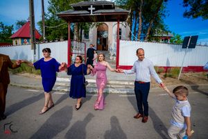 Wedding guests perform coordinated dance moves during outdoor celebration.
