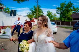 Outdoor wedding celebration features synchronized dance routine with formal attire.