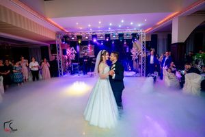 Wedding ballroom with elegant lighting design and atmospheric fog effects.