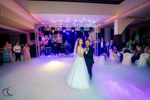 Luxurious wedding venue with purple ambient lighting and fog-filled dance floor.