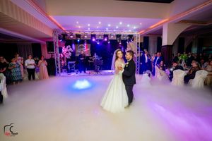 Elegant wedding reception venue with purple lighting and fog effects on the dance floor.