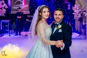 Romantic first dance moment captured under starlit wedding venue lighting.
