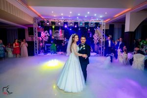Wedding venue featuring dramatic lighting and fog effects during first dance.
