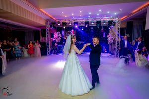 Wedding celebration space with fog-filled dance floor and ambient purple lighting.