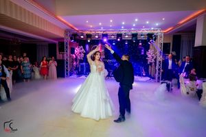Ballroom decorated with ambient lighting and dance floor setup for an elegant celebration.