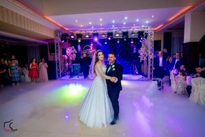 Wedding venue with atmospheric lighting and fog effects creating a dreamy dance floor atmosphere.
