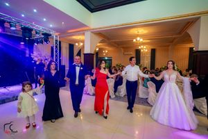 Wedding celebration showing dance floor panorama with elegant lighting and formal atmosphere.