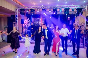 Elegant ballroom filled with dancers under theatrical lighting and overhead truss system.