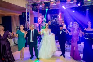 Wedding celebration with guests dancing under colorful stage lights and truss lighting system.