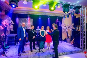 Social dance event with stage lighting creating a dynamic atmosphere in an elegant venue.